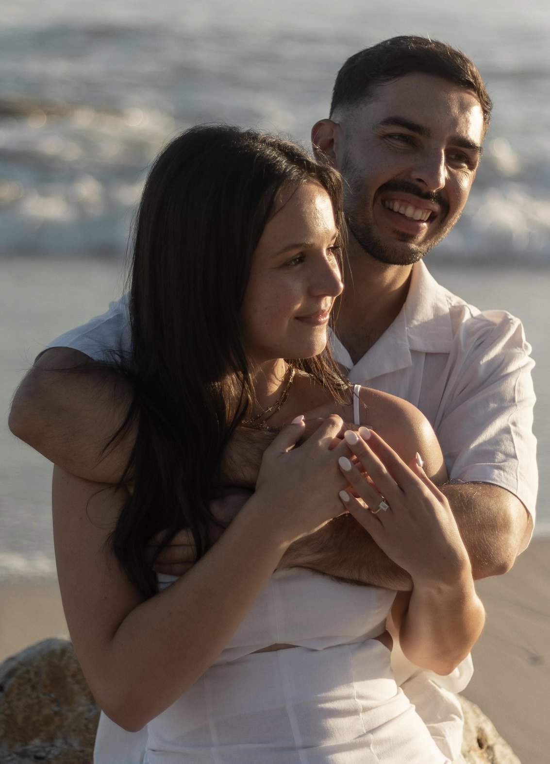 Tiaan holding Bianca from behind, both laughing
